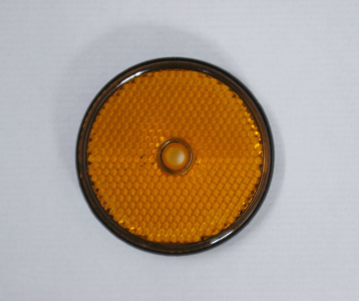 REFLECTOR REDONDO D.60MM LARANJA C/ ADESIVO E FURO